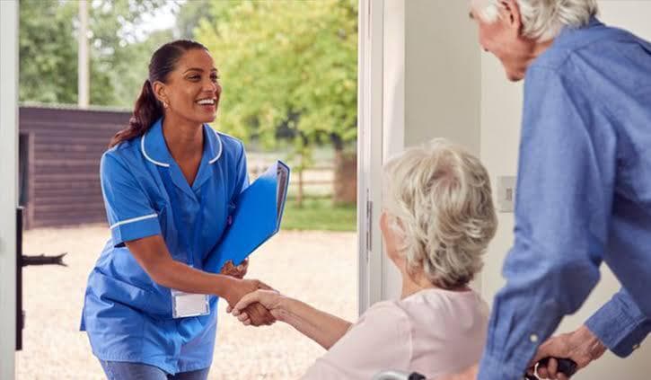 Smiling nurse holding medical record